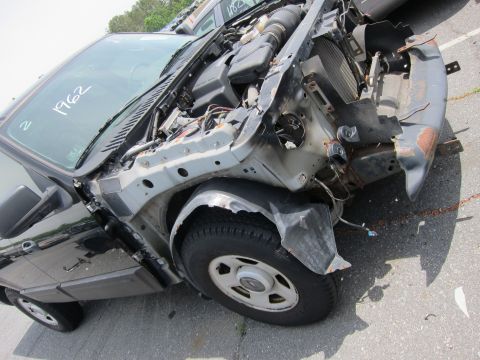 1991 Ford LTD Crown Victoria - This heavily damaged vehicle shows significant front-end collision impact, with the engine compartment exposed.