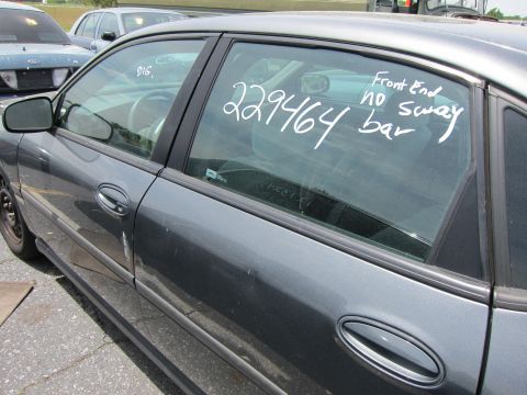 1991 Ford LTD Crown Victoria - Side view of a gray sedan with handwritten notes on the window, another vehicle in background.