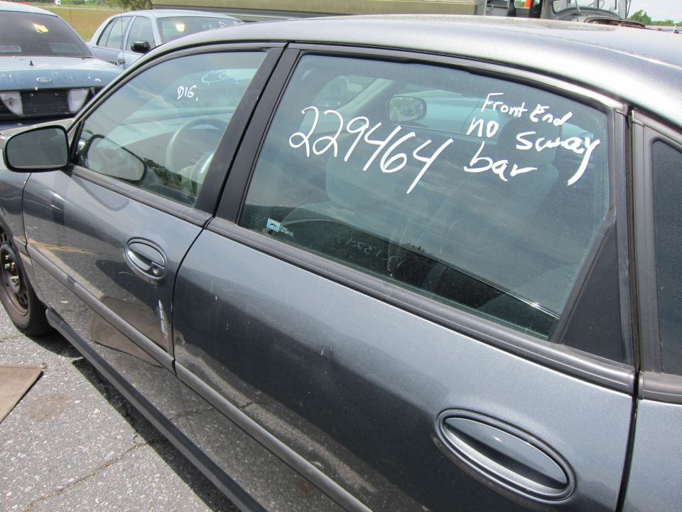 Gray sedan side view, with writing on window: 229464 Front End no sway bar. Another car is visible in the background