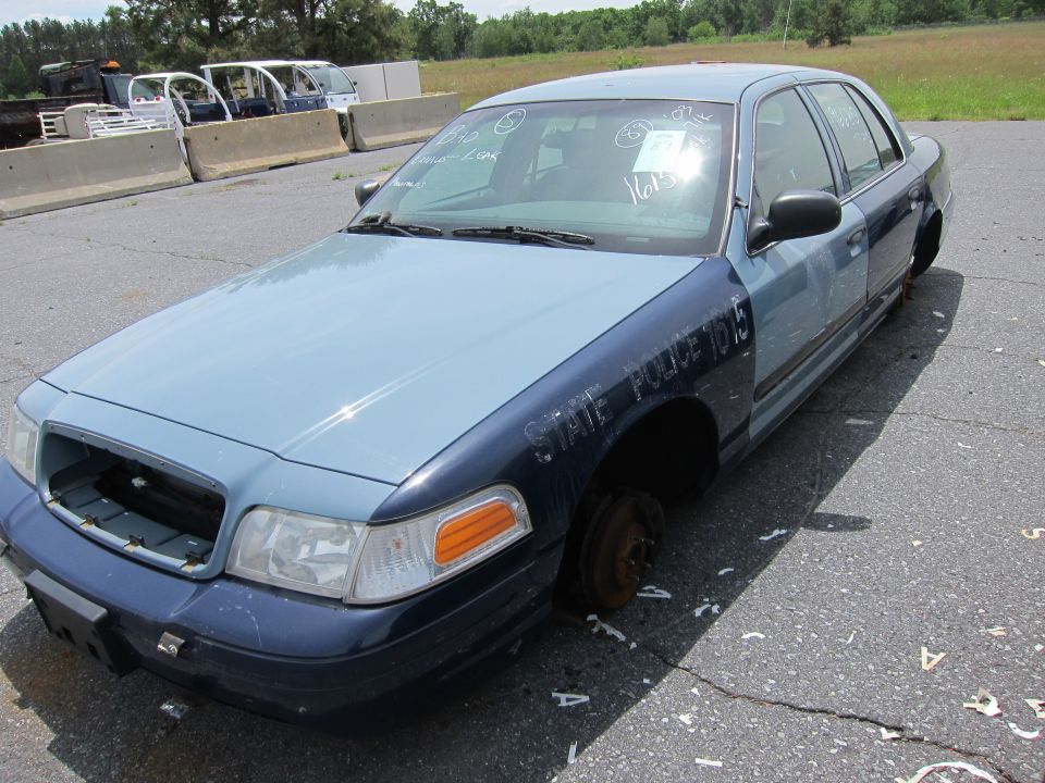 Two-tone police car with "STATE POLICE 1015" text, missing wheels