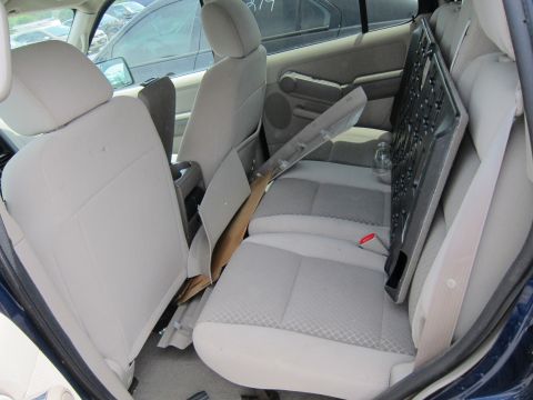 1991 Ford LTD Crown Victoria - The interior of a vehicle is cluttered with various items, including trim pieces and cardboard, obscuring the view of the seats.