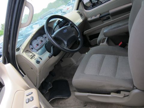 1991 Ford LTD Crown Victoria - The interior of a Ford Explorer shows the dashboard, steering wheel, and front seats. The odometer reads approximately 100,000 miles.