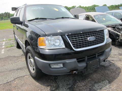 1991 Ford LTD Crown Victoria - Black Ford Expedition parked in a lot with other vehicles.