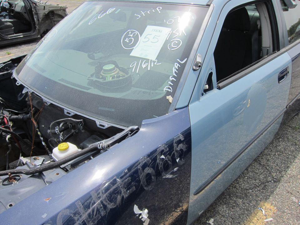 Blue car door and fender with handwritten markings on windshield