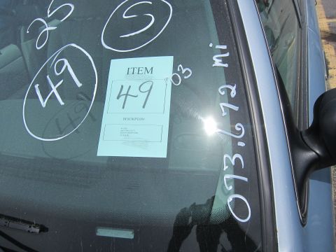 1991 Ford LTD Crown Victoria - Auction item sticker and mileage visible on the windshield of a vehicle.
