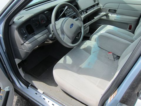 1991 Ford LTD Crown Victoria - Interior of a Ford Crown Victoria, likely a 2003 model, showing the dashboard and front seats.