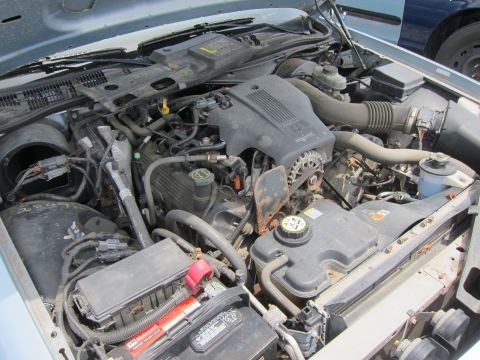 1991 Ford LTD Crown Victoria - The engine bay of a vehicle, showing various engine components and wiring.