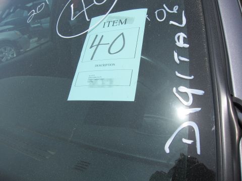 1991 Ford LTD Crown Victoria - Auction tag on windshield with handwritten notes and another vehicle in the background.