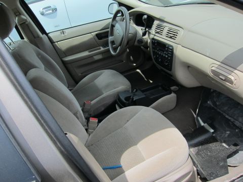 1991 Ford LTD Crown Victoria - Interior view of a car showing the front seats, dashboard, and center console.
