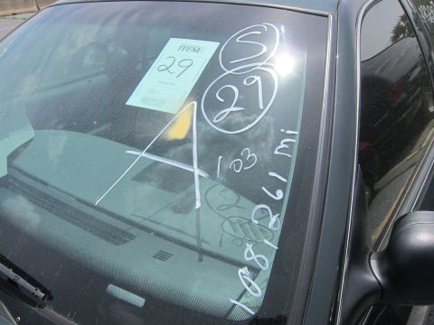 1991 Ford LTD Crown Victoria - Auction markings on the windshield of a vehicle, including item number 29 and mileage 108,261 miles.