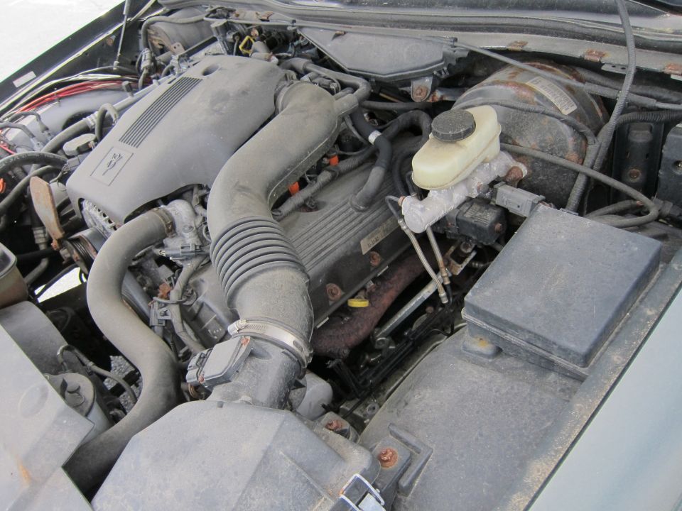 Engine bay with V8 engine, air intake, brake fluid reservoir, and fuse box