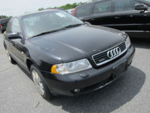 1991 Ford LTD Crown Victoria - A black Audi A4 sedan is parked in an outdoor lot, showing its front grille and headlights.