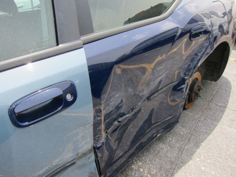1991 Ford LTD Crown Victoria - This car has significant damage to the rear quarter panel and door, and is missing a wheel.