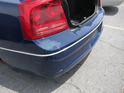 1991 Ford LTD Crown Victoria - Rear view of a blue car showing damage to the bumper and open trunk.