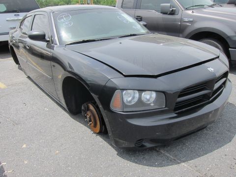1991 Ford LTD Crown Victoria - This black Dodge Charger is missing its front wheels and has its hood open.