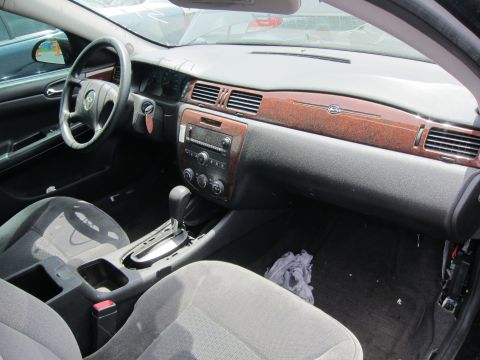 1991 Ford LTD Crown Victoria - Interior view of a car, showing the dashboard, steering wheel, and seats. The wood grain trim is a prominent feature.
