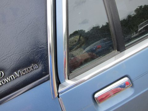 2001 Ford Crown Victoria - Close-up of a 2001 Ford Crown Victoria's side door panel and window, showing the model name badge.