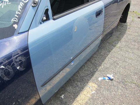 1991 Ford LTD Crown Victoria - A car door with two different shades of blue paint is visible, with some debris on the ground.