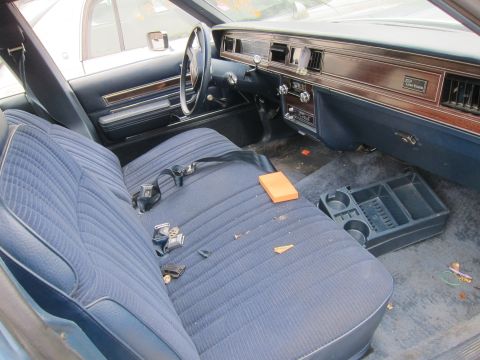2001 Ford Crown Victoria - Interior view of a blue Custom Cruiser, a bench seat, wood-grain trim, and dashboard details.