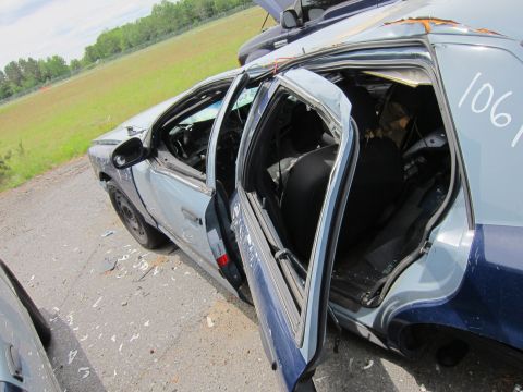 1991 Ford LTD Crown Victoria - Interior view of a wrecked 1991 Ford Crown Victoria LTD police car, with visible damage and debris.