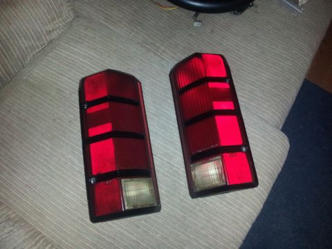 1988 Ford Bronco - Two red taillights with black trim are shown, likely for a vehicle.