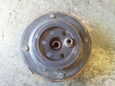 2005 Chevrolet Venture - A Ford clutch pressure plate is shown resting on a concrete surface.
