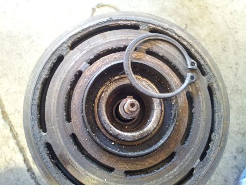 2005 Chevrolet Venture - Close-up of a worn air conditioning compressor clutch assembly, showing the central shaft and retaining clip.