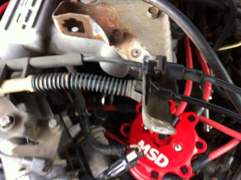 1992 Ford F-150 - Unbolt the bracket shown above that hold the cable from the upper intake plenum and fold the cables and bracket out of the way.