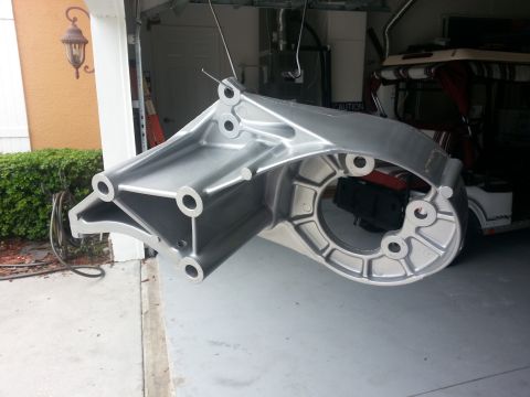 1994 Ford Bronco - A metal bracket is the main focus, with a golf cart in the background.