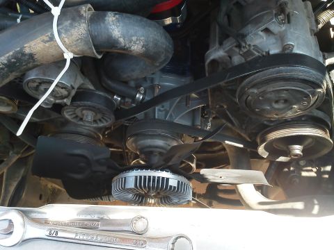 1988 Ford Bronco - Close-up view of an engine bay, focusing on the fan clutch and serpentine belt system.