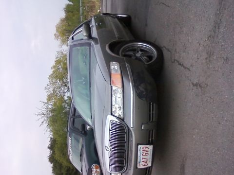 2001 Mercury Grand Marquis - The front grille and headlights of a 2001 Mercury Grand Marquis are visible.