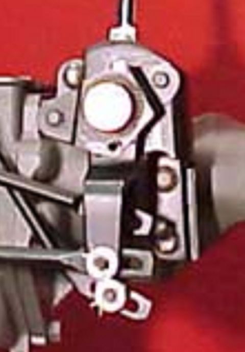 1973 Ford Ranchero - A detailed view of a vehicle's carburetor, showing its mechanical components.
