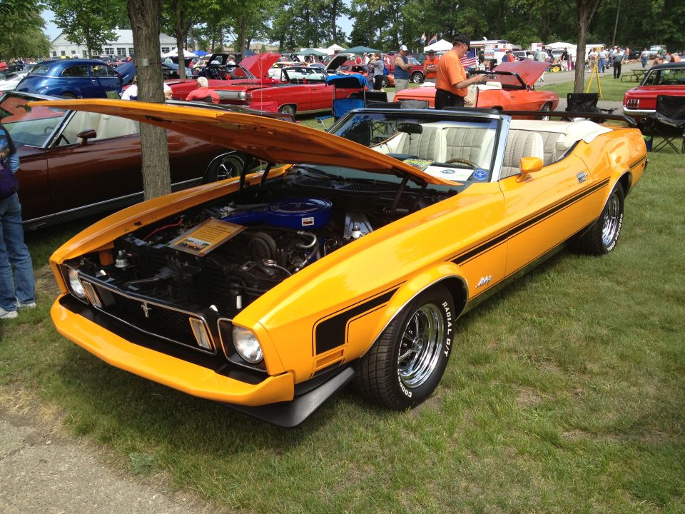 Yellow 1971 convertible with hood open, showing engine and white interior