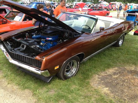 1988 Ford Bronco - Brown 1970 Ford Torino GT convertible on display at a car show.