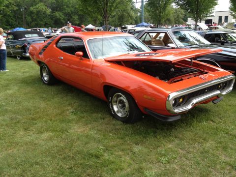 1988 Ford Bronco - A 1971 Plymouth Road Runner is displayed with its hood open at a car show.
