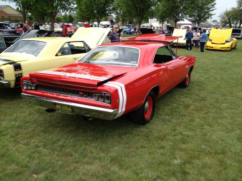 1988 Ford Bronco - Rear view of a red 1968 Dodge Coronet R/T at a car show, with other vehicles present.