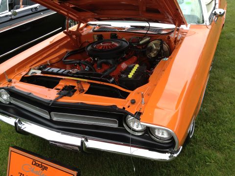 1988 Ford Bronco - The engine bay of an orange Dodge Challenger is displayed, with a sign indicating it is a 1971 model.