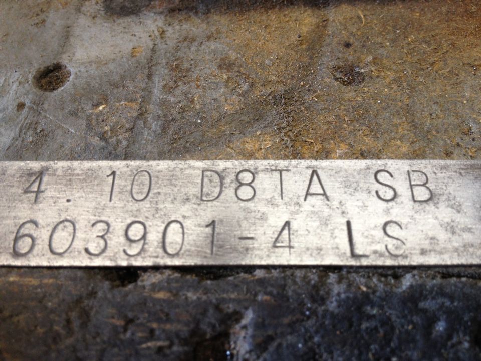 Close-up of metal plate with stamped numbers and letters: 4.10 D8TA SB 603901-4 LS