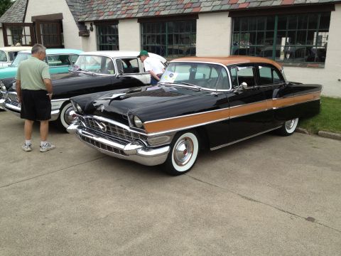 1988 Ford Bronco - A black and tan Packard sedan from the mid-1950s is displayed at an outdoor car show.
