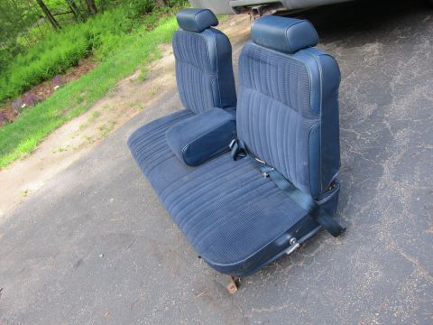 2001 Ford Crown Victoria - Blue velour front car seats with headrests and armrest are shown outside.