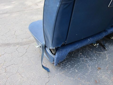 2001 Ford Crown Victoria - Close-up of a blue car seat, showing its construction and a dangling seatbelt.