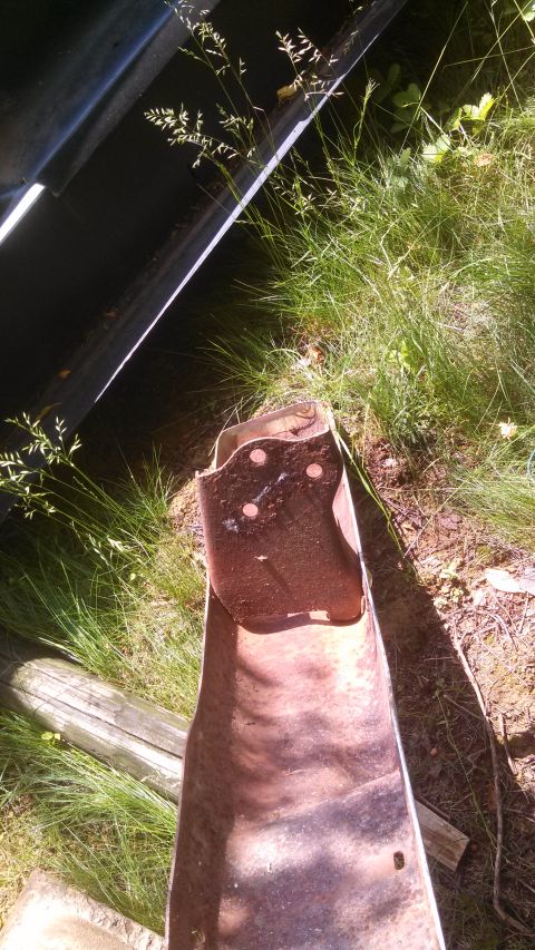1979 Ford Bronco - A close-up view of a heavily rusted metal part, possibly from a vehicle, with visible bolt holes and a Supermotors.net watermark.