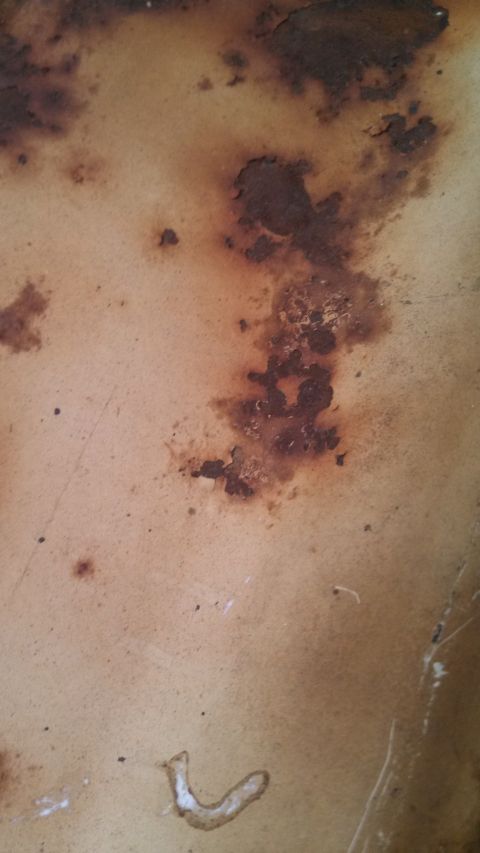 1979 Ford Bronco - This image shows a heavily rusted metal surface, not a 1979 Ford Bronco.