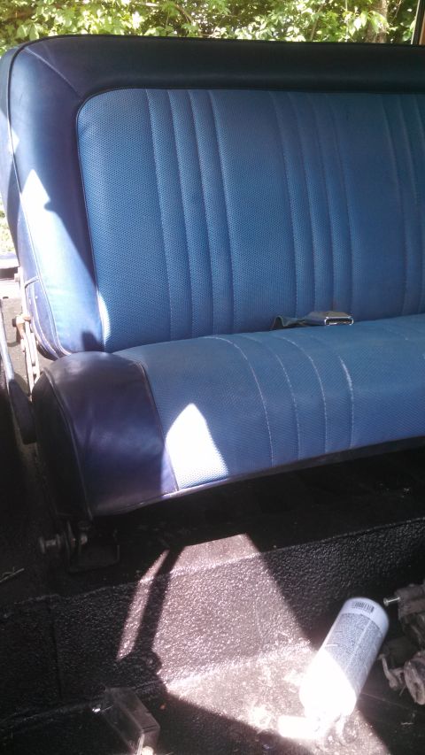 1979 Ford Bronco - Interior view of a blue vinyl seat with dark blue trim and a seatbelt.