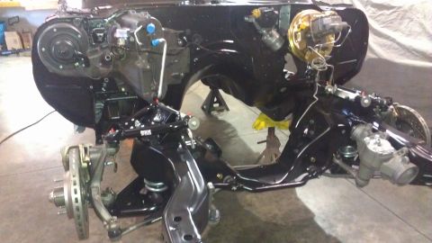 1972 Pontiac Trans Am - The front end of a car is disassembled, showing the suspension and chassis components.