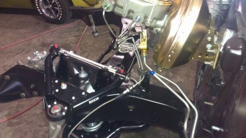 1972 Pontiac Trans Am - Close-up of vehicle chassis components, including suspension and brake system parts, with another vehicle partially visible.
