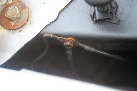1976 Ford Ranchero - A close-up view of a corroded electrical connection point on a vehicle's frame.