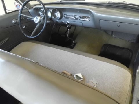 1963 Ford Fairlane - The interior of a 1963 Ford Fairlane shows a bench seat and dashboard.