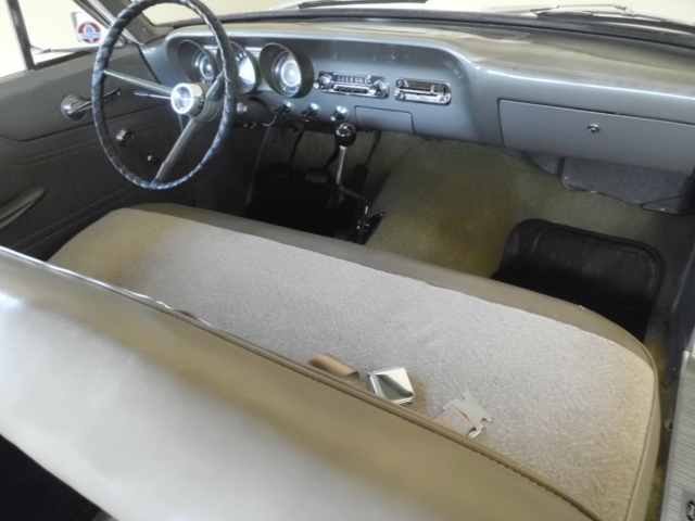 1963 Ford Fairlane interior with bench seat, dashboard, and steering wheel