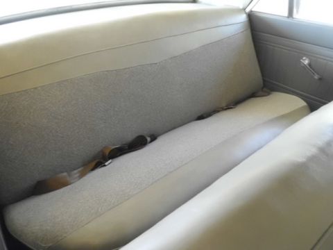 1963 Ford Fairlane - Interior view of the rear seat in a 1963 Ford Fairlane, showing the seat pattern and seatbelts.